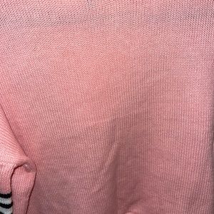 Pink hoodie with black and white striped detail